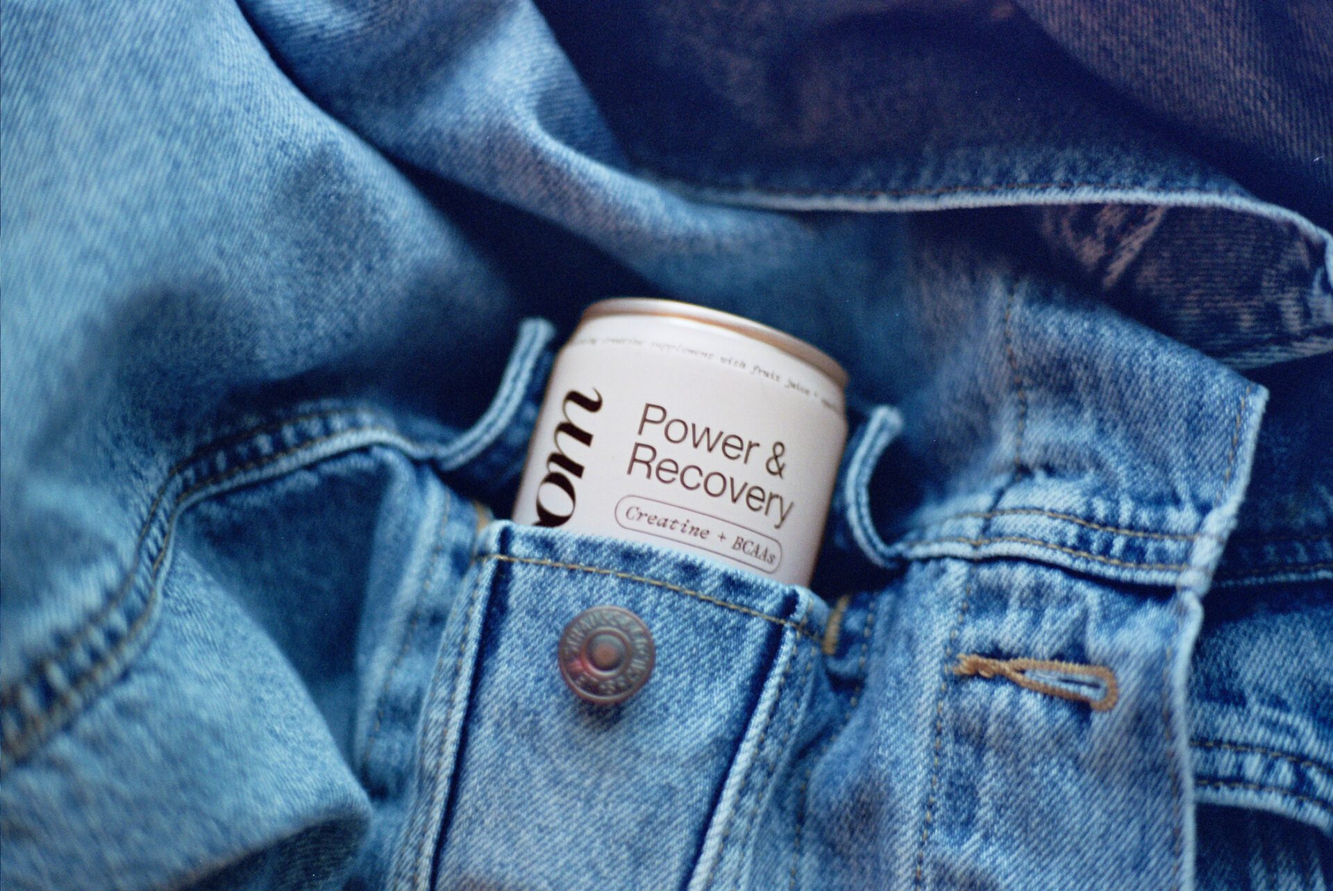 Konsoom Crisp Blueberry Power & Recovery can tucked into a denim jacket pocket